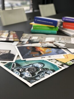 Printed photo assets sit on a desk.