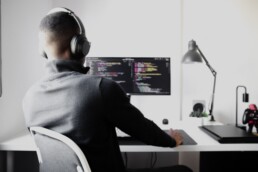 Person coding on a computer desktop