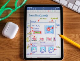 iPad displaying a sketch to a website wireframe