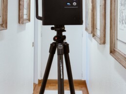 A camera is set up in a hallway, ready to take photos.