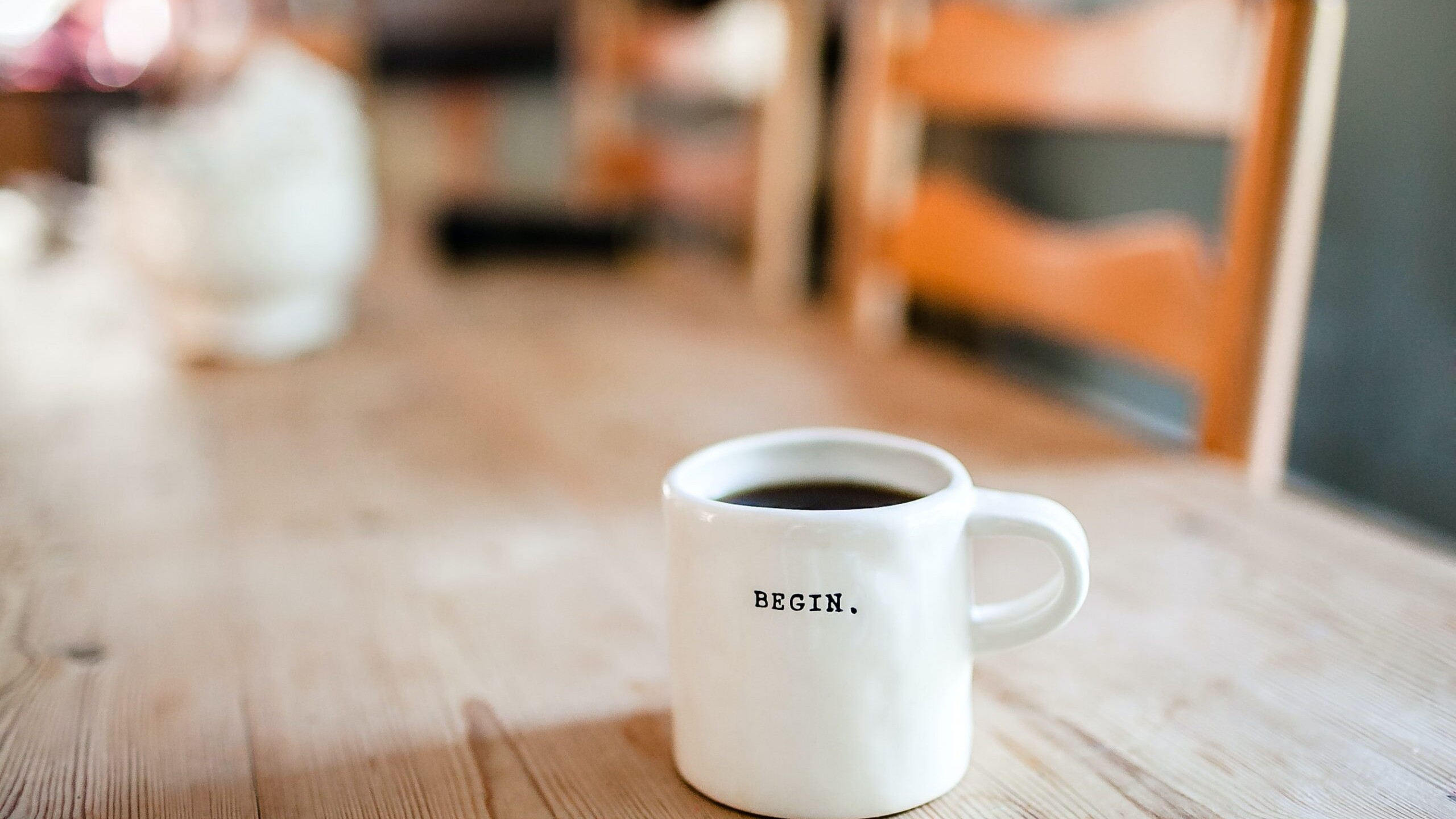 A coffee mug showcases the word 
