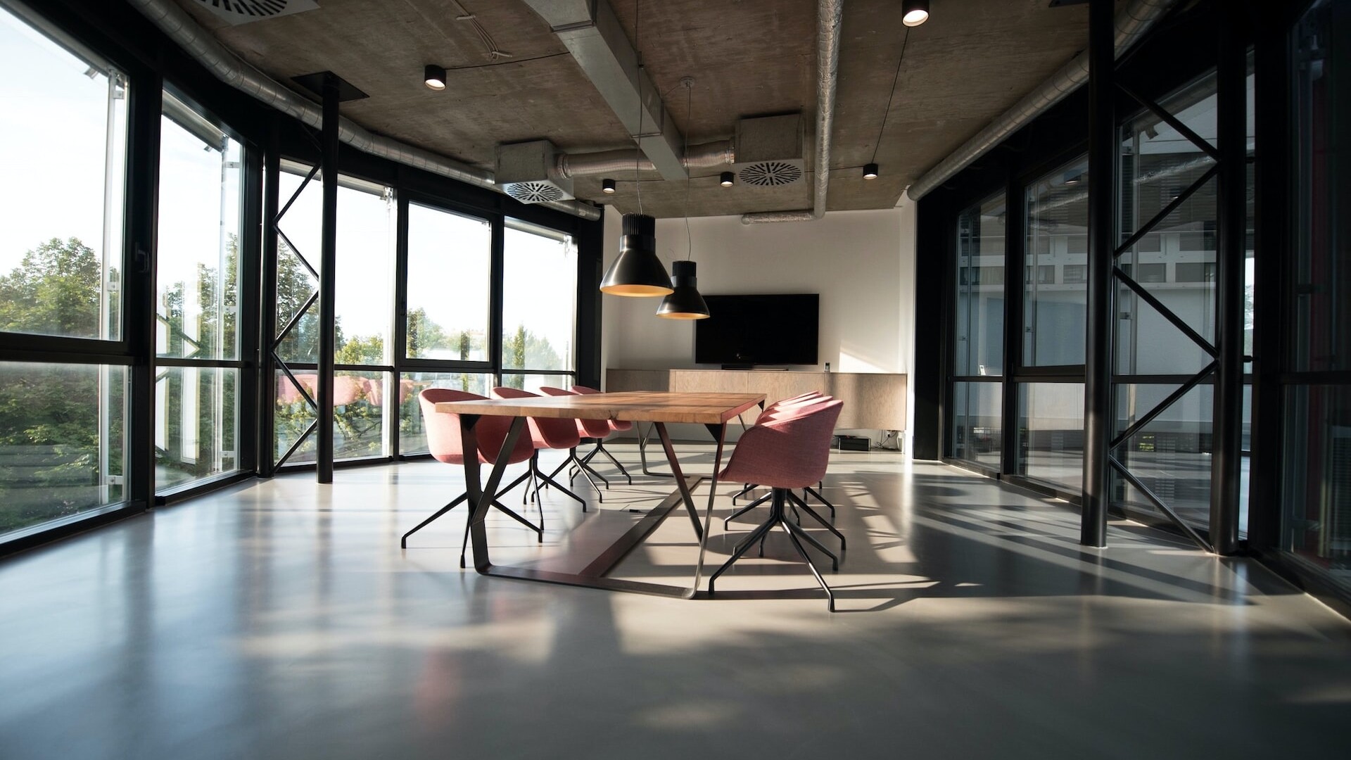 Design Agency Office Space with one large conference table and chairs in an empty room.