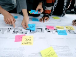 Designers planning out journey map with post-it notes.