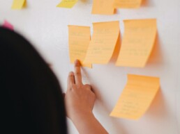 Designer using sticky notes to create user journey.