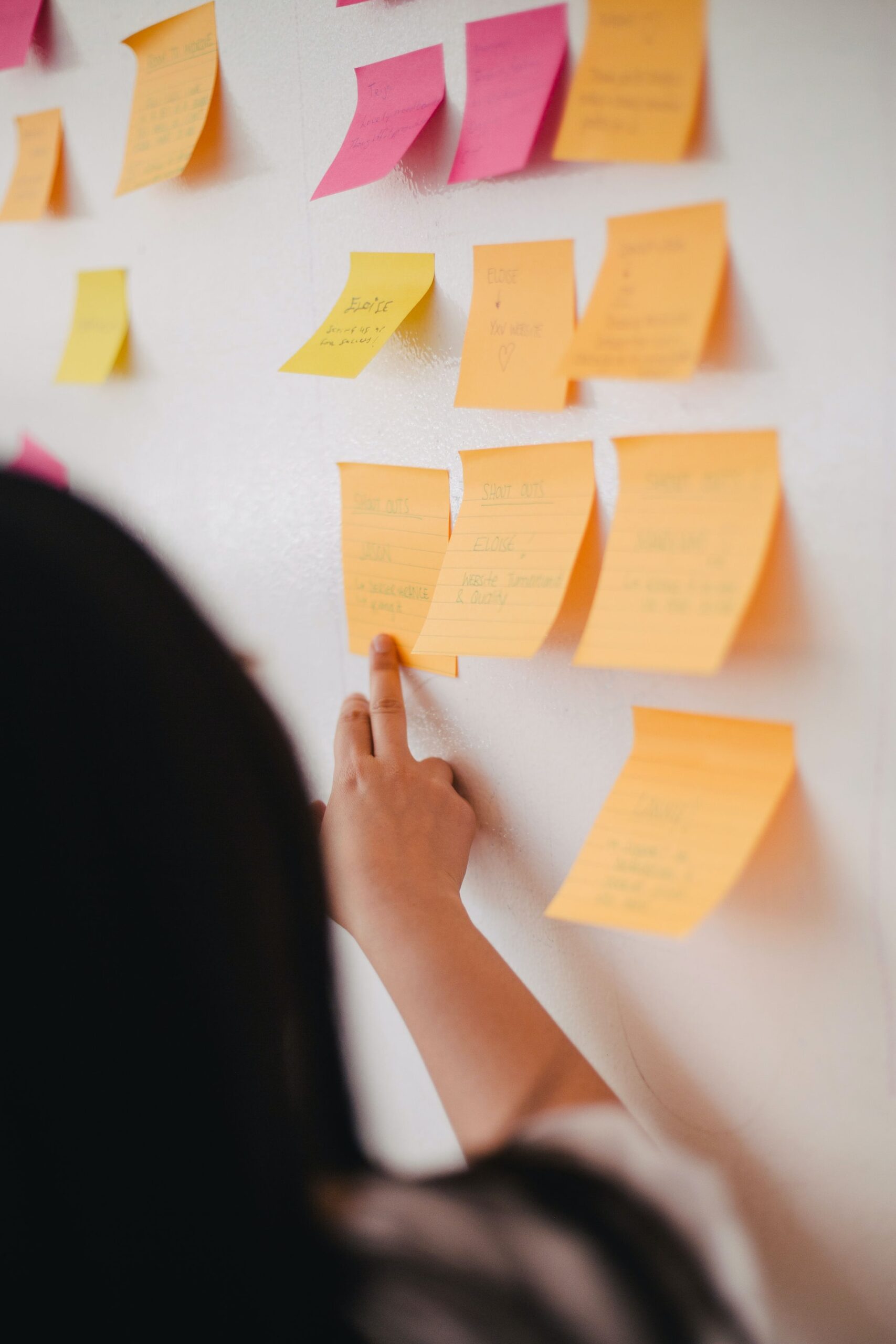 Designer using sticky notes to create user journey.