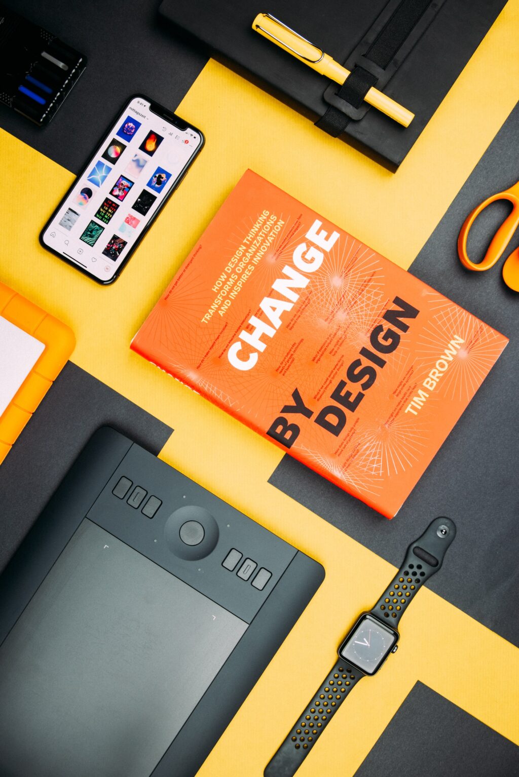 Books on a yellow table about UX design strategy