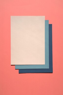 White paper design with three sheets of blank paper.