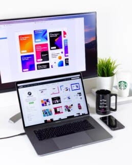 Desktop and laptop screens both displaying a design website