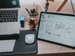 Ipad on a desk displaying a wireframe sketch