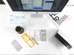 Eagle eye view of a desktop with product design materials on desk