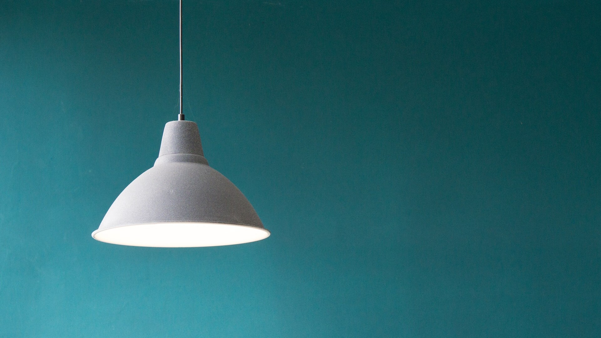Simplistic design lamp on green background.