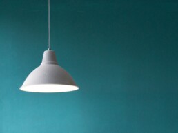 Simplistic design lamp on green background.