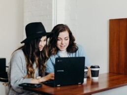 Two users on a laptop engaging with AMP