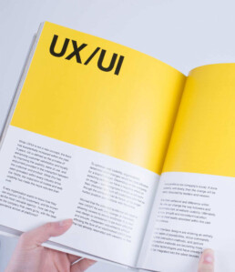 versions book opened to a UX/UI page